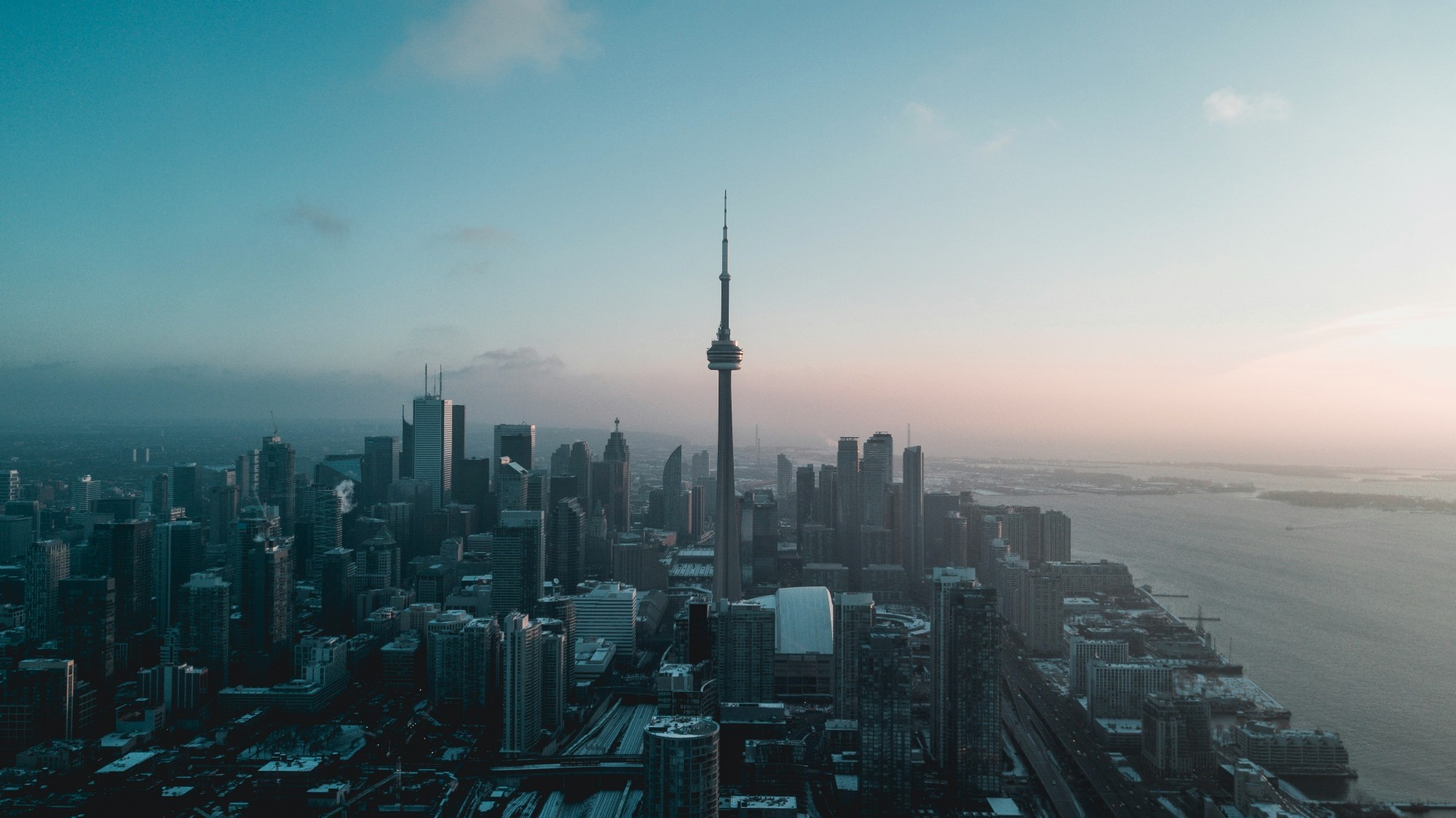 Downtown Toronto and the Lake Ontario shoreline from the air at winter dusk, the CN Tower at the centre
